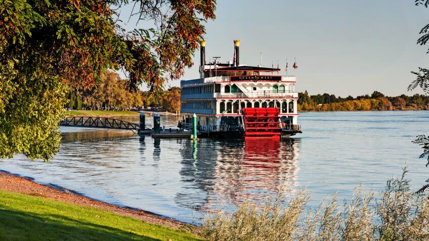 Richland, Washington, USA - September 21, 2014: This paddle boat the Queen of the West is moored on the Columbia River in Richland Washington at the Amon Park a great local and tourist venue for recreation in the Tri-Cities the walking paths the landscaped park on this early morning looked peaceful and very inviting.