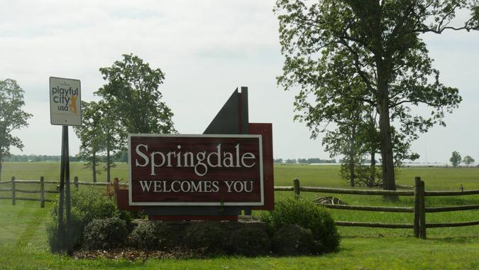 SPRINGDALE, ARKANSAS—MAY 2017: Roadside sign surrounded by plants in Springdale, the fourth largest city dubbed as a “playful city” in Arkansas.