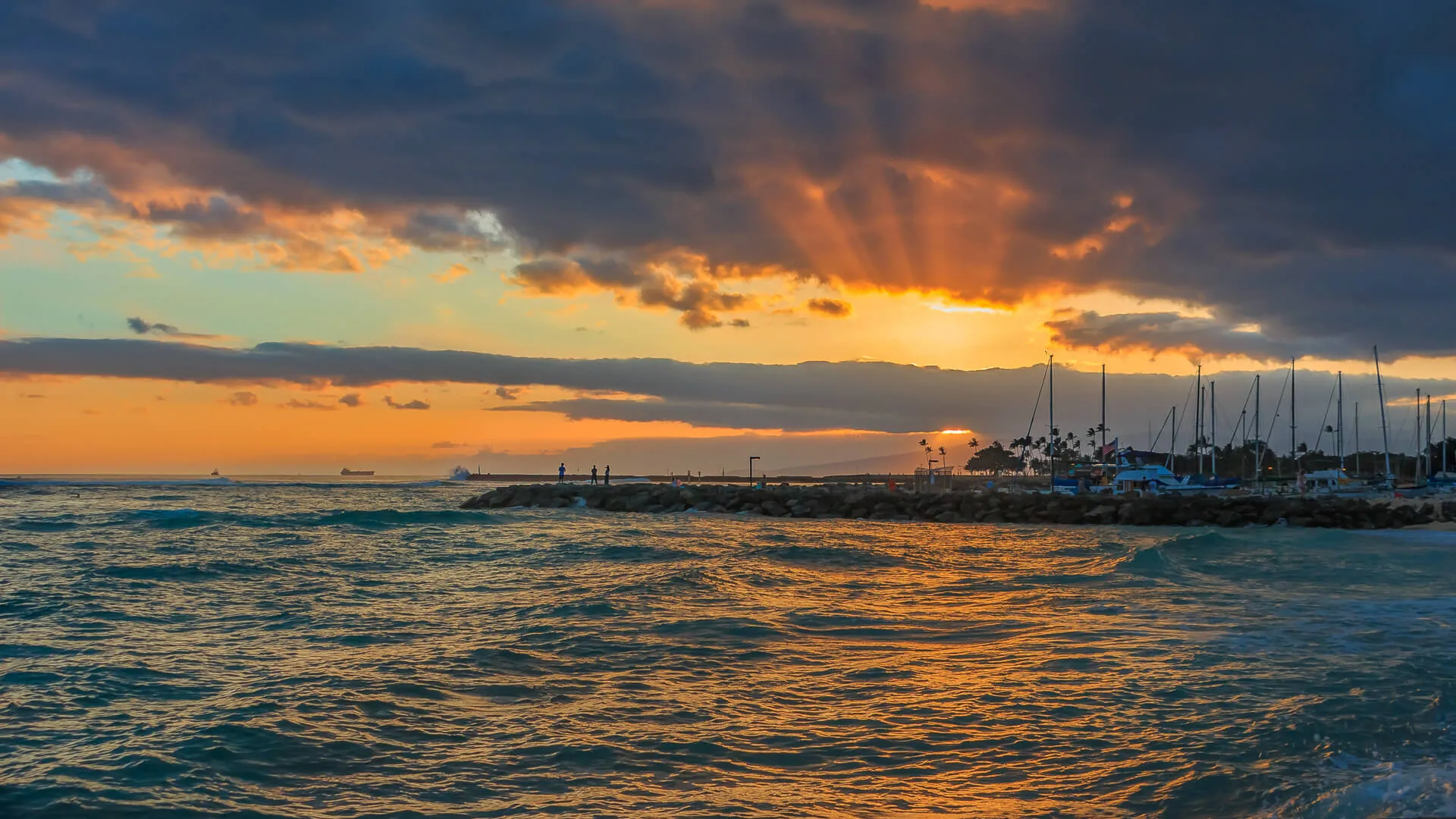 Stunning sunset with sunbeams shining through storm clouds in Waipahu, Oahu, Hawaii - Image.