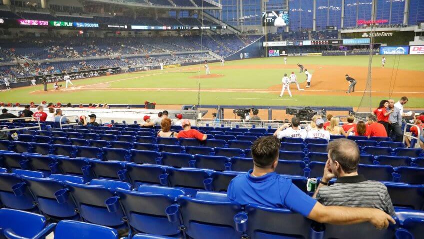 baseball fans watching game with empty stadium