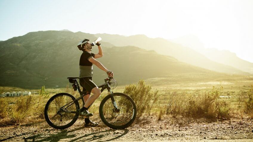 Shot of a mature man having a water break while out for a ride on his mountain bike.