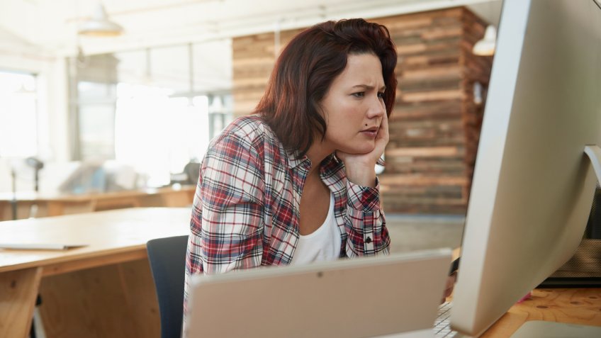Shot of a young female designer looking confised as she looks at her computer screenhttp://195.