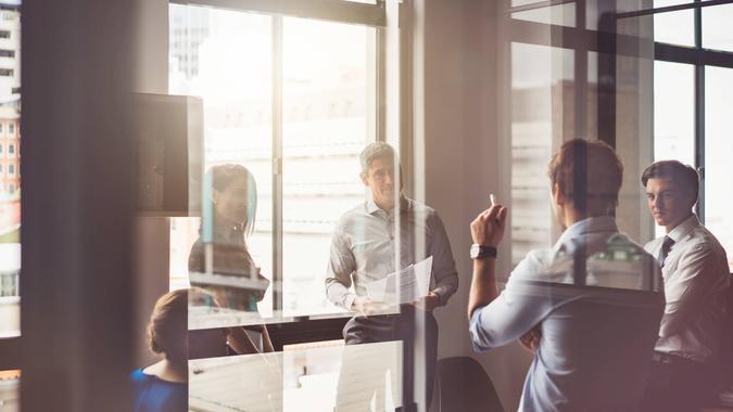 A photo of business people having discussion in board room.
