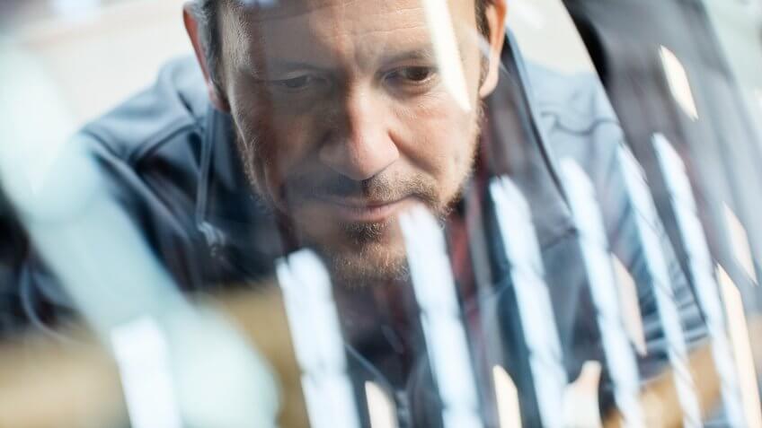 Close-up of male engineer seen through car windshield.