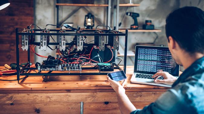 Programmer preparing mining rig with GPU.