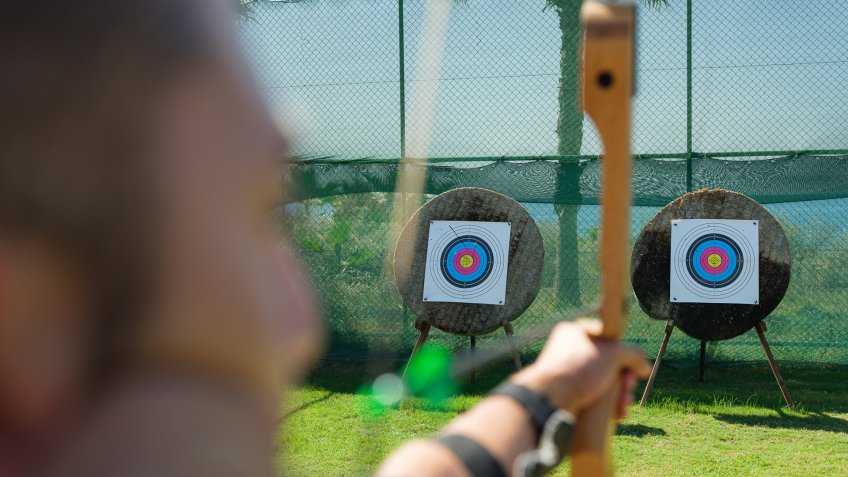 Young man Learning How to Use Bow and Arrow.