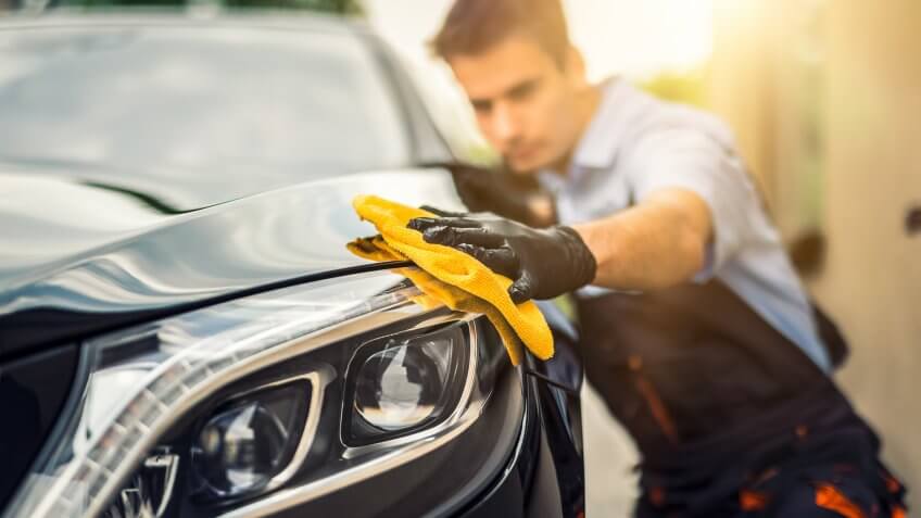 guy waxing brand new car