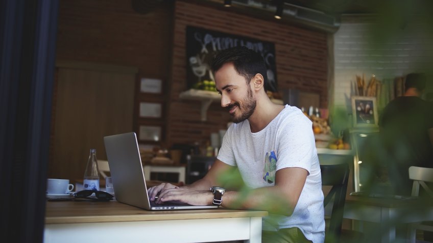 guy working on laptop in coffee shop