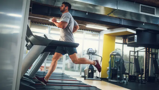Male running on treadmill at the gym.