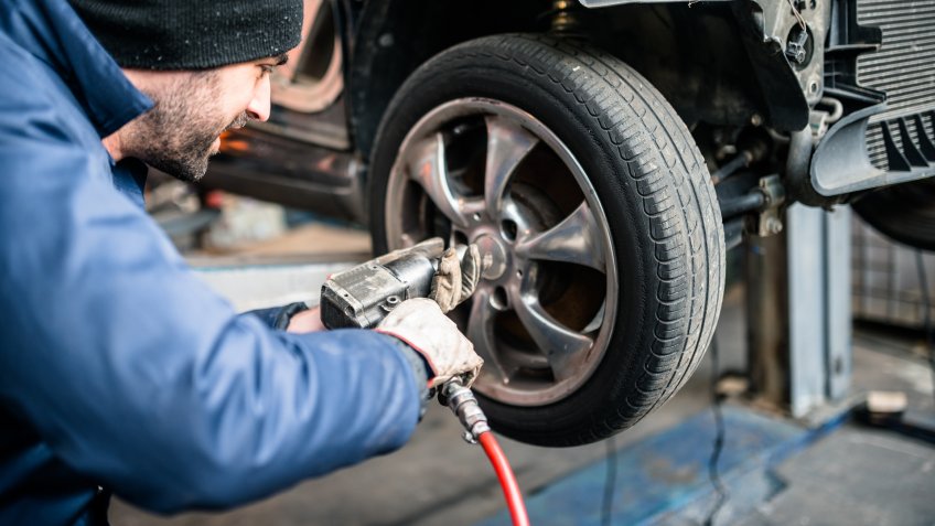 tire repairer changing the car tire.