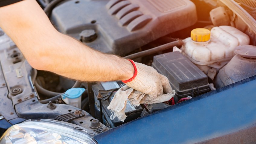mechanic cleaning battery connection