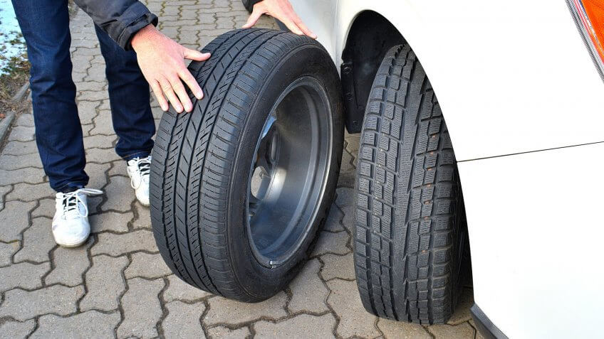 mechanic with multiple types of tires