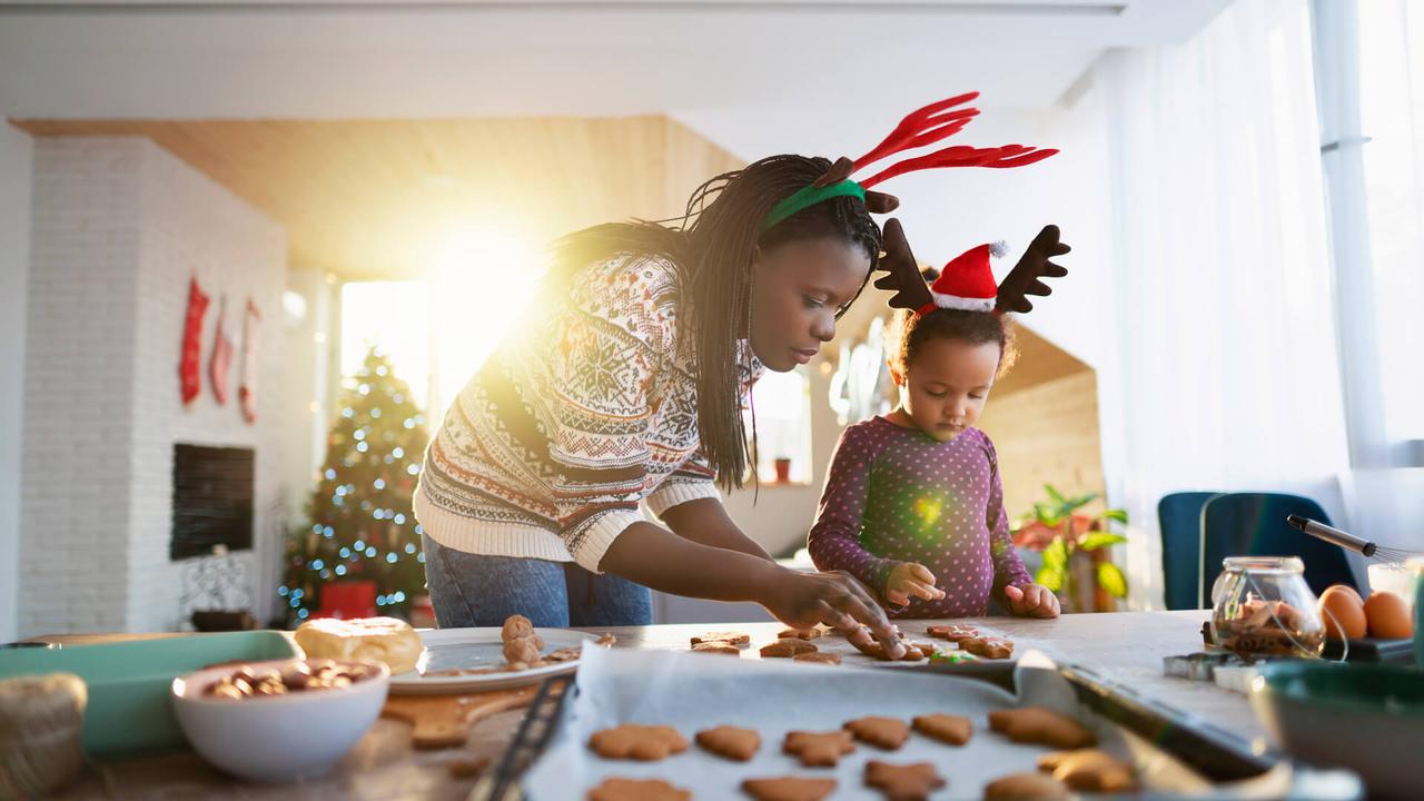 Mother making Christmas cookies with her daughter.