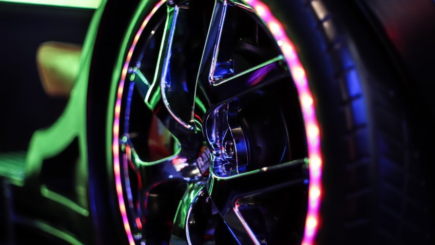 Seattle, Washington/USA - September 29, 2019 - Closeup of neon lights of a tire car driving simulator in an arcade games center.