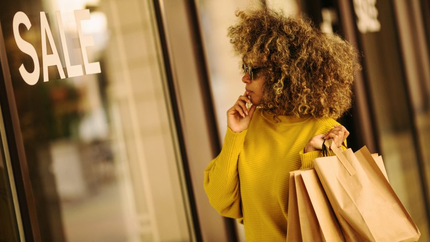 Beautiful female walking and shopping in mall.