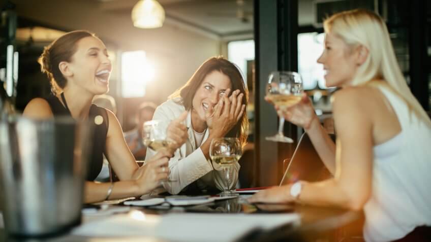 Close up of a group of business people having a drink after work.