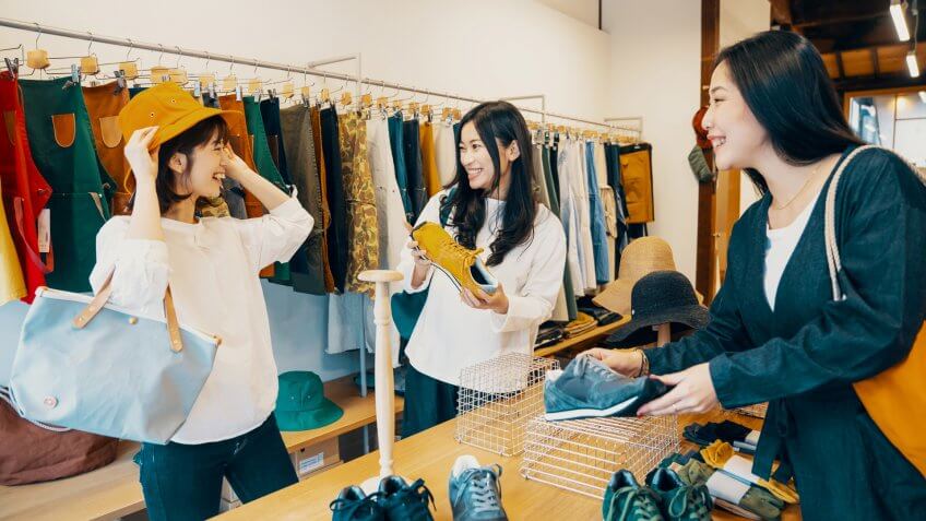Three women shopping together in a clothing store in Japan.