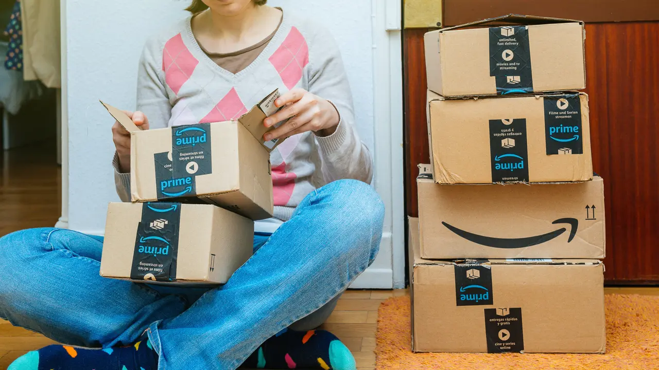 woman opening up Amazon delivery boxes