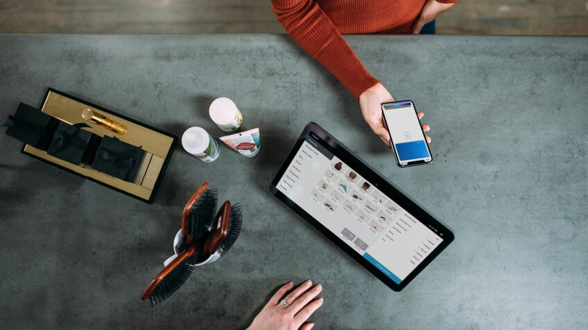 woman using Apple Wallet to make purchase