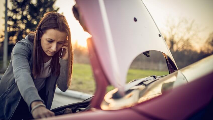 Woman having problem with her car, it stopped on the street.