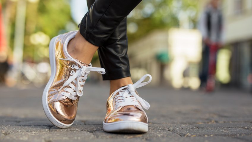 woman with stylish luxury sneakers