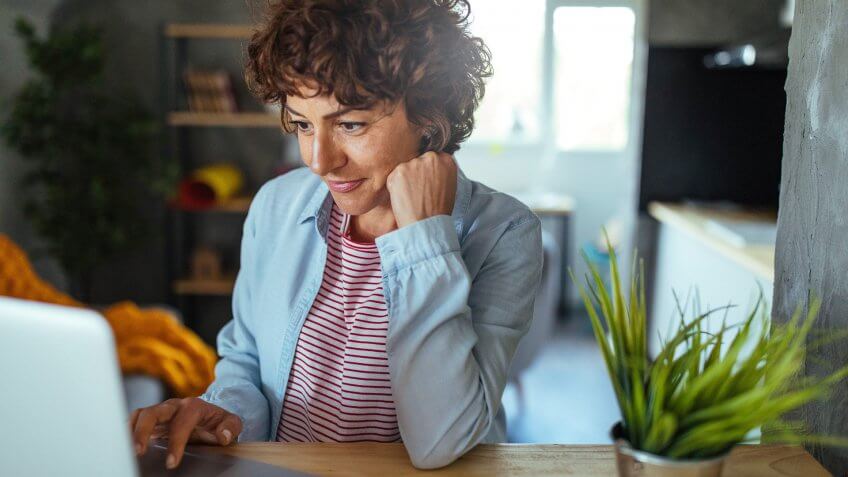 Photo of mature woman working at home.
