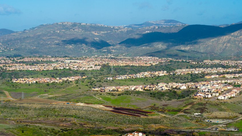 View from the top of the Black Mountain of Carmel Valley with suburban neighborhood with identical villas next to each other.