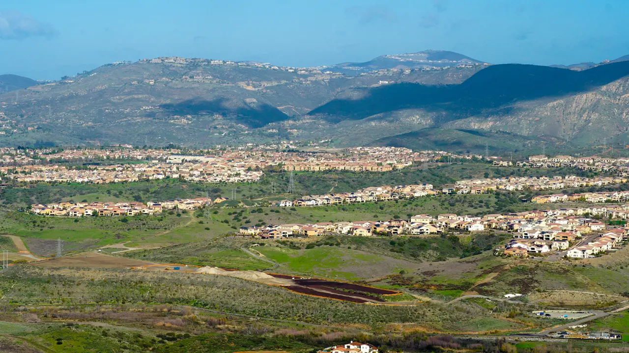 View from the top of the Black Mountain of Carmel Valley with suburban neighborhood with identical villas next to each other.