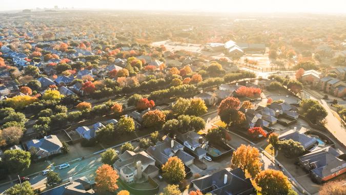 Aerial view urban sprawl with colorful fall foliage near Dallas, Texas, USA.