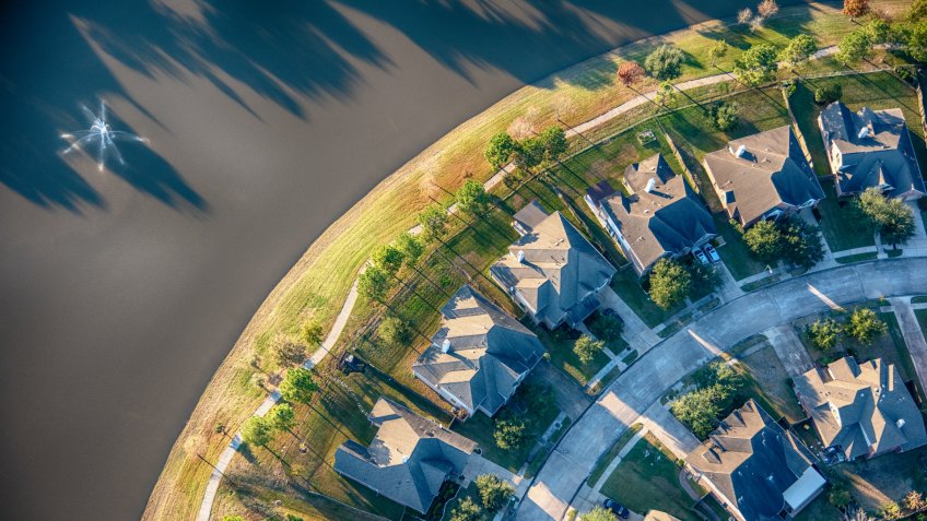 Aerial view of a residential subdivision in the suburbs of Houston, Texas consisting of water front homes and manicured landscaping.