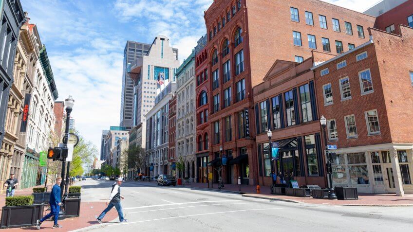 Louisville, Kentucky, USA - April 13, 2019: People walking on West Main Street, among the old buildings at downtown.