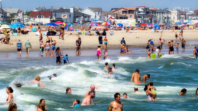 SPRING LAKE, NEW JERSEY-AUGUST 20 - A crowd of sunbathers and swimmers enjoy a warm beach day on August 20 2016 in Spring Lake New Jersey.