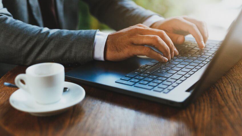 Close up of hands on laptop with copy space.