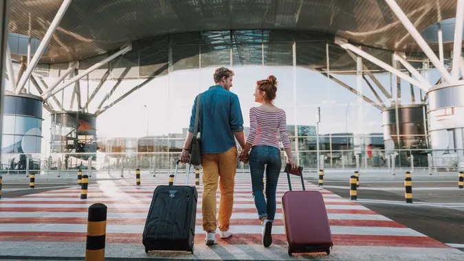 Male Passenger Using Baggage Check Weighing Machine at Airport