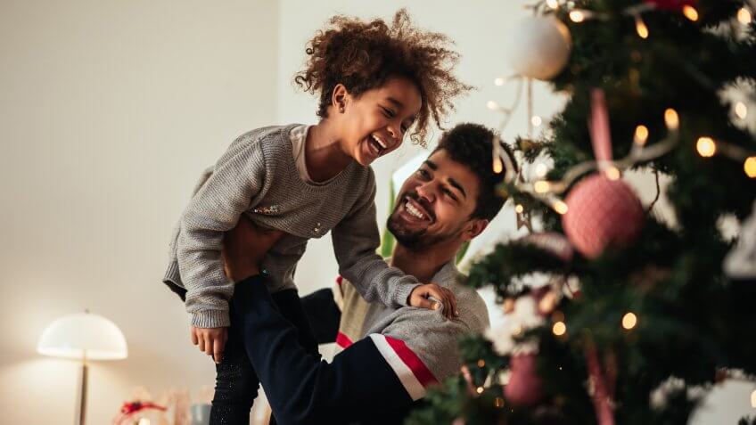 Shot of an african american father and daughter celebrating Christmas with love at home.