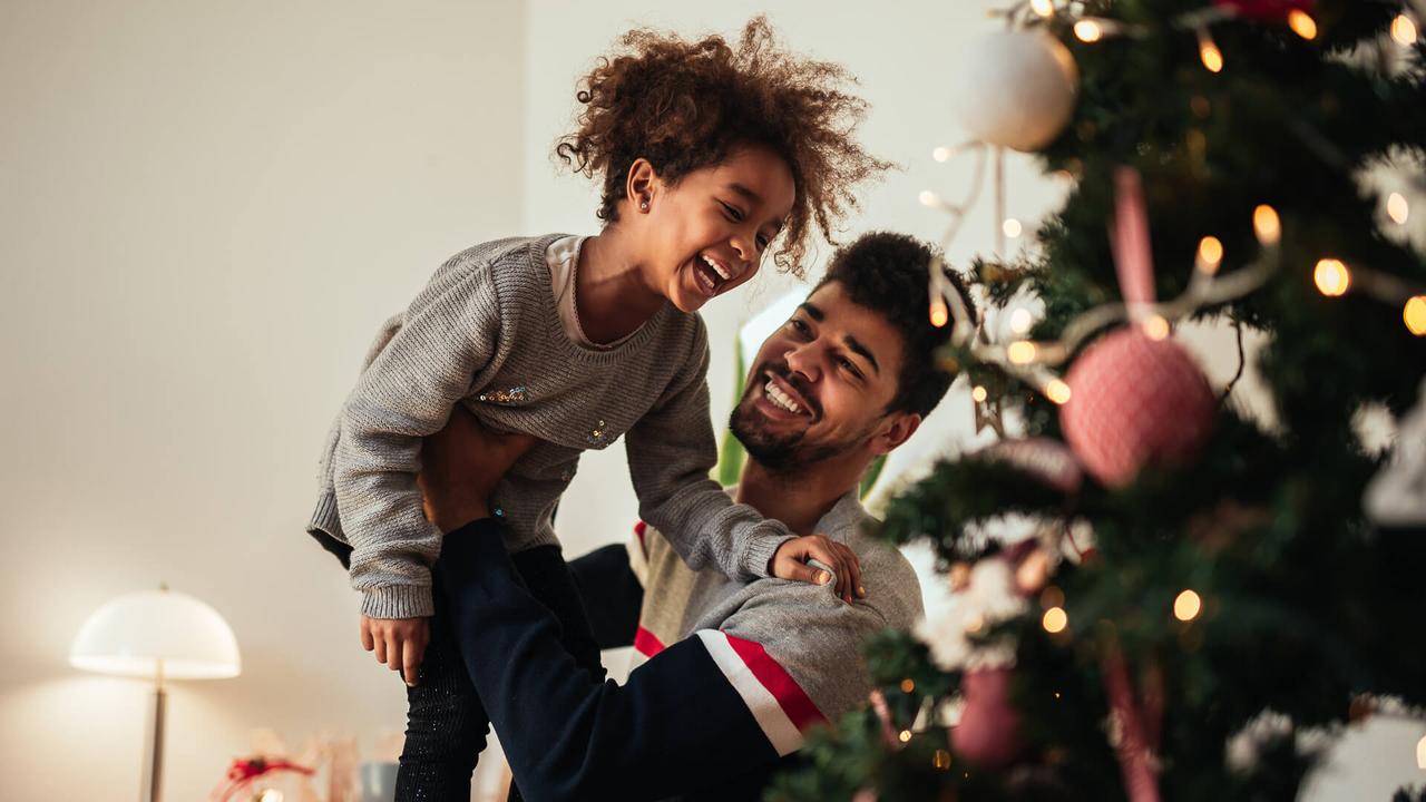 Shot of an african american father and daughter celebrating Christmas with love at home.