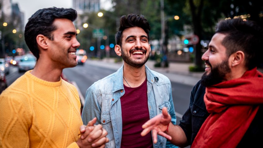 Group of three male friends walking around Mexico city.