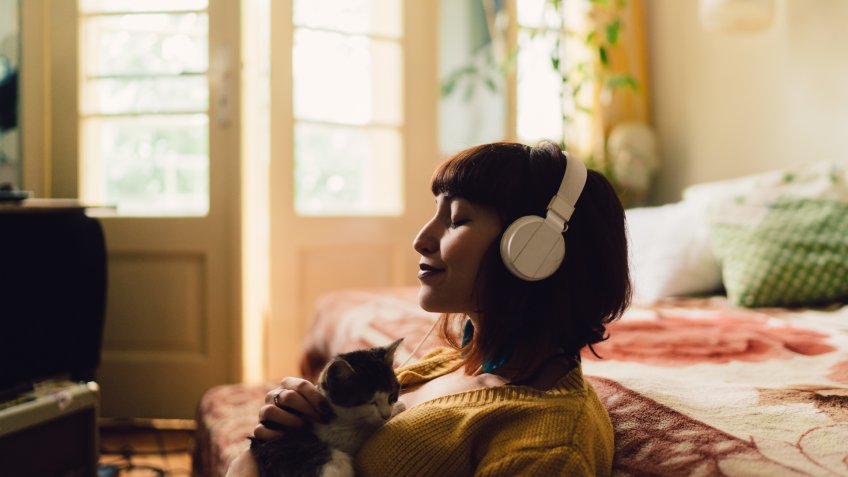 Teenage girl with cat at home relaxing during the weekend.