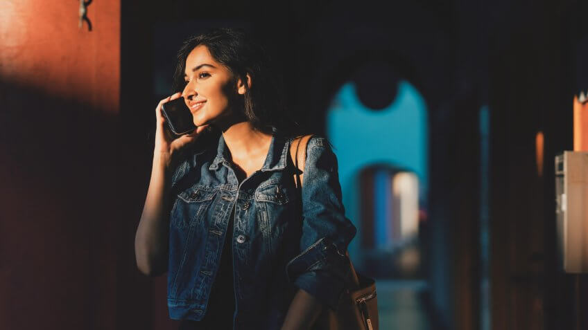 beautiful asian female staying connected on the go.
