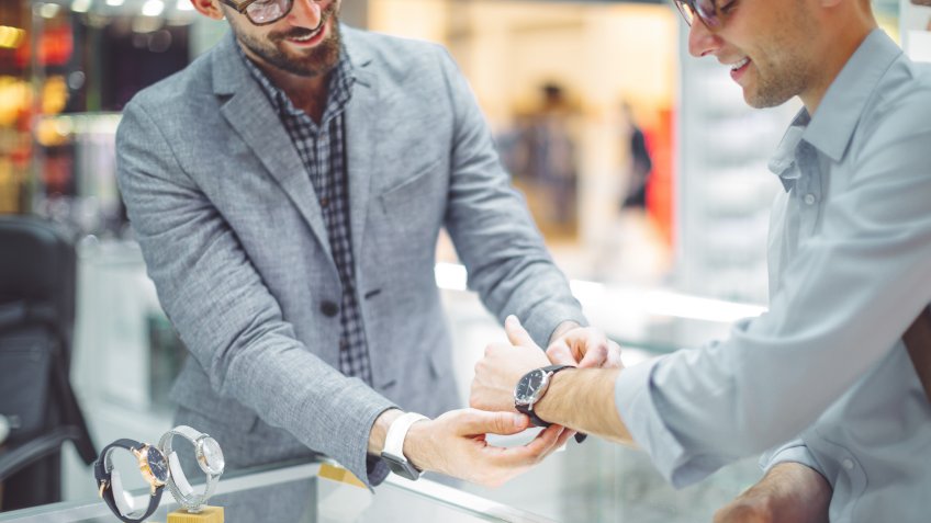 Young man is shopping for a watch.