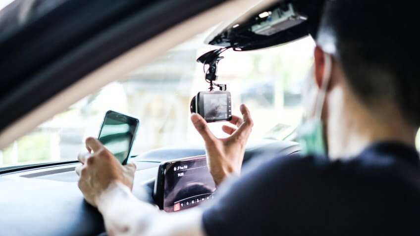guy turning on dashboard camera