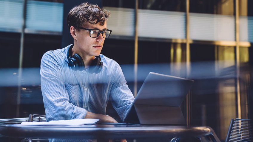 guy with headphones working on tablet