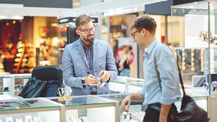 Young man is shopping for a watch.