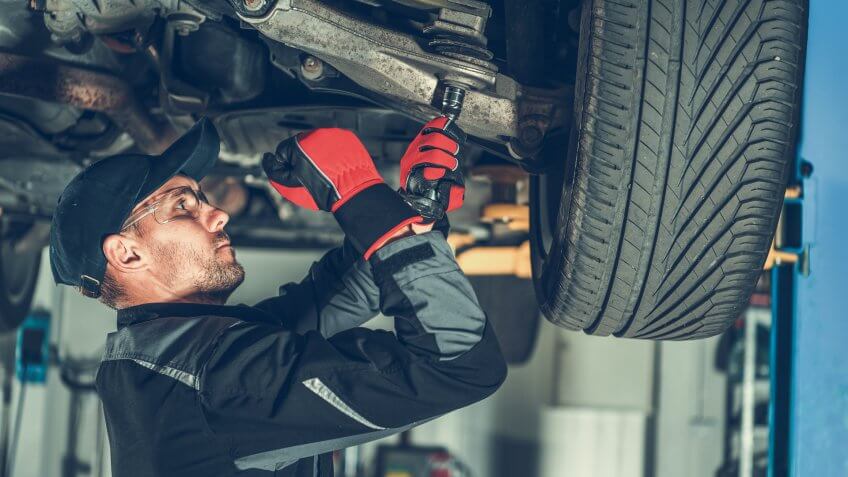 mechanic changing suspension bushings
