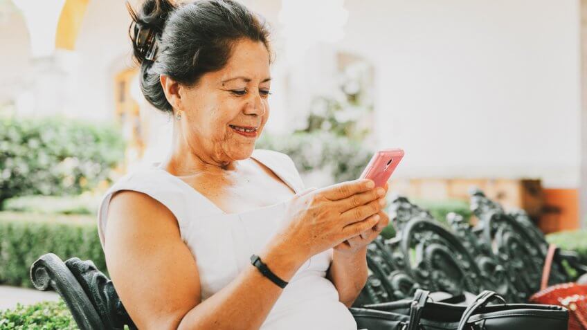Senior Mexican Woman Using Smart Phone.