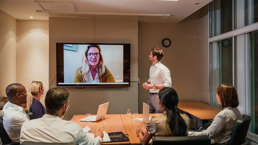 Group of business people having a late night video conference meeting.