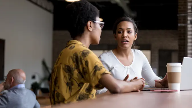 Woman has serious conversation with friend while in coffee shop.