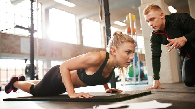 trainer with woman exercising