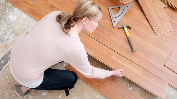 woman placing hardwood floor