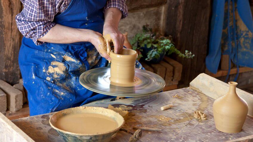 person making pottery